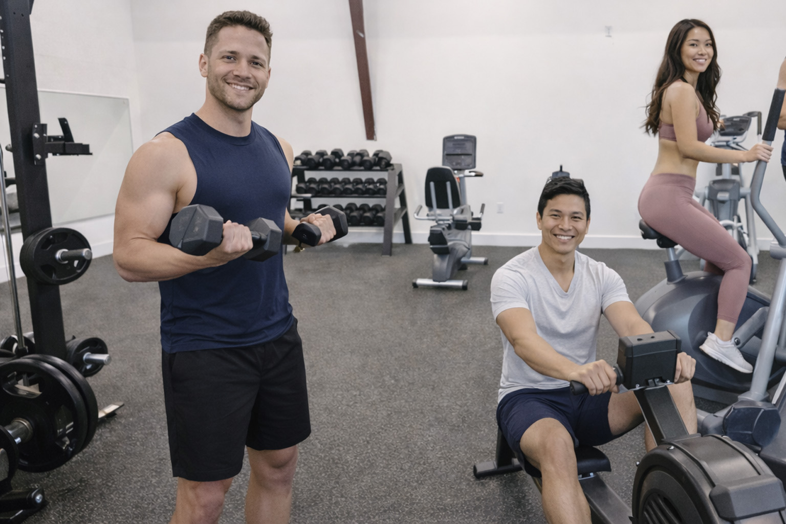 Guests working out in the fitness center at the Beach Club at Whalehead in Corolla, North Carolina, featuring cardio machines and free weights in a modern Outer Banks vacation rental amenity gym