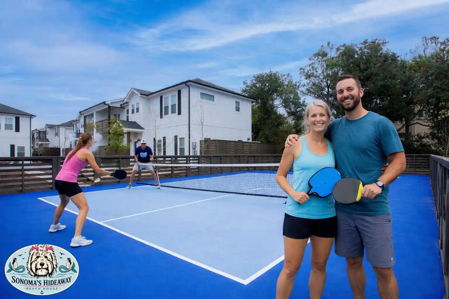 Guests playing pickleball at the Beach Club at Whalehead in Corolla NC, with Sonoma’s Hideaway branding, showcasing outdoor courts and fun amenities for an Outer Banks vacation rental