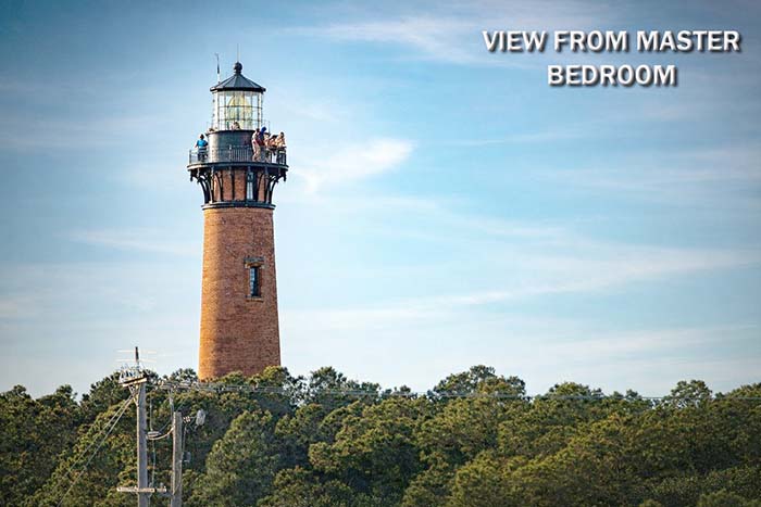 View of the Currituck Beach Lighthouse in Corolla, Outer Banks, North Carolina, as seen from the primary bedroom deck at Sonoma’s Hideaway