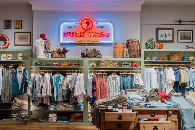 Interior of a stylish coastal boutique in Duck, North Carolina featuring beach-inspired clothing, accessories, and local apparel displays in the Outer Banks.