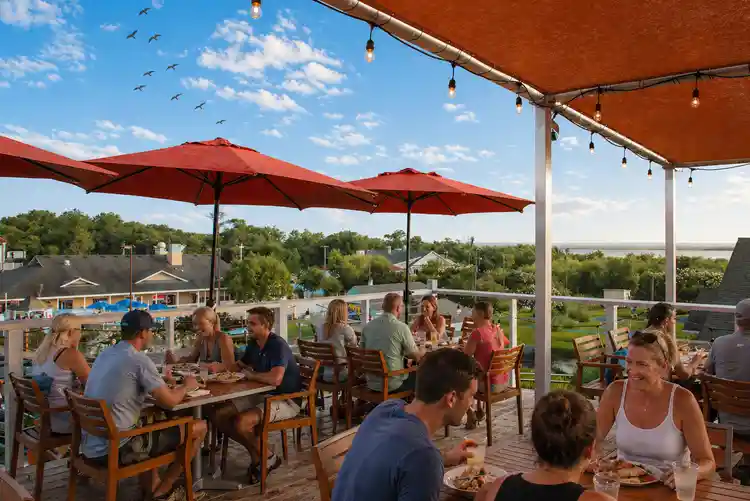Friends enjoying drinks on a rooftop deck in the Outer Banks