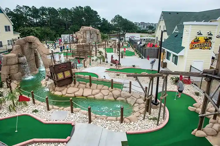 Families enjoying pirate-themed mini golf at Pirate’s Island course in Corolla, Outer Banks, North Carolina.