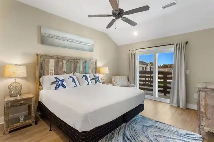 Spacious master bedroom at Sonoma’s Hideaway in Corolla Outer Banks with king bed, coastal decor, and private deck access with lighthouse views