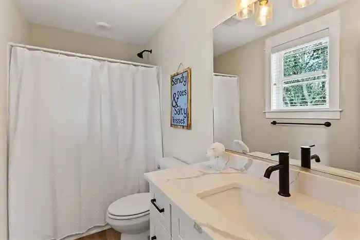Private bathroom for second bedroom at Sonoma’s Hideaway in Corolla Outer Banks with walk-in shower, modern vanity, and bright coastal design