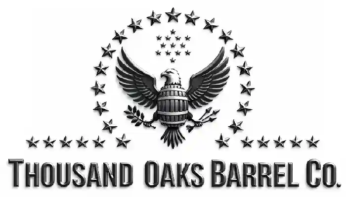 Beveled metallic logo for Thousand Oaks Barrel Co. featuring a bald eagle with outstretched wings holding a barrel, olive branch, and arrows, surrounded by stars above bold capital lettering.