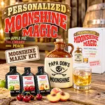 Personalized Moonshine Magic DIY moonshine making kit featuring a custom Papa Don's Moonshine ceramic jug with pirate skull design, three premium flavor essences in Apple Pie, Cherry, and Peach, branded gift box, and whiskey glass in a rustic home bar setting.