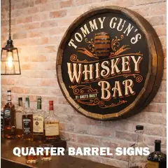 Personalized quarter barrel whiskey bar sign mounted on a brick wall in a well-lit home bar with liquor bottles and glasses displayed on the counter below.