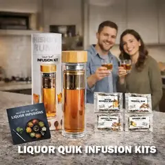 Liquor Quik Infusion Kit displayed on a kitchen counter with whiskey infusion bottle and flavor packets while a happy couple enjoys whiskey in rocks glasses in the background.