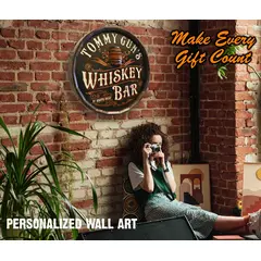 round wooden whiskey bar barrel end sign mounted on stone wall in home bar setting with womanand  product specs