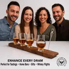 Group of people tasting whisky with a whisky stave flight board holding four Glencairn glasses and pipette.