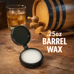 .25oz barrel wax tub in rustic setting beside oak aging barrel and whiskey glass, used for sealing stave seams and preventing spirit evaporation.