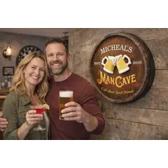 Couple standing beside handmade 20 inch round personalized barrel end man cave sign with raised beer mugs