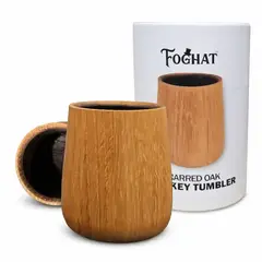 Foghat charred oak whiskey tumbler displayed in front of its packaging, featuring a handcrafted wooden design with a dark charred interior.