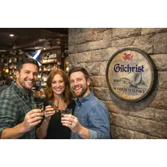 Friends enjoying Scotch whisky in home bar with Gilchrist barrel end wall decor displayed behind them