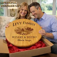 Couple opening personalized barrel head lazy susan gift with custom engraved family name and vineyard design.