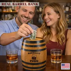 Couple placing money into bourbon fund oak barrel piggy bank while enjoying whiskey drinks