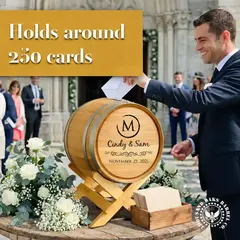 Wedding guest placing envelope into personalized wedding card barrel holder during an outdoor wedding ceremony reception.