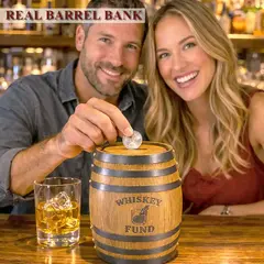 Couple dropping a coin into a mini oak barrel whiskey fund piggy bank while enjoying whiskey drinks at a bar