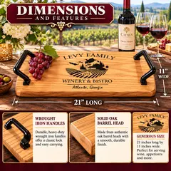 Personalized oak winery and bistro serving tray with custom family name and vineyard engraving, displayed with red wine glasses, wine bottle, and grapes on a sunlit patio overlooking scenic vineyards.