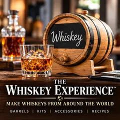 The Whiskey Experience oak barrel aging kit featuring a 1–2 liter charred American white oak barrel with chalkboard front, wooden stand, spigot pouring whiskey into a glass, flavor essences, and instructional booklet for making homemade whiskey at home.