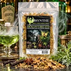 Dragon's Breath® Absynthe scented oak wood chips for cocktail smokers, featuring aromatic licorice and herbal notes. Premium infused wood shavings displayed with a smoky green absinthe cocktail, star anise, and botanicals. Ideal for whiskey smokers, bourbon cocktails, smoking guns, and Foghat cocktail smoker kits.