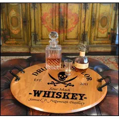 Authentic 21-inch round oak barrel head serving tray with wrought iron handles displaying whiskey decanter and glass in a rustic bar setting. 'Drunken Sailor' Barrel Head Serving Tray