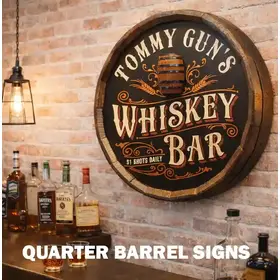 Personalized quarter barrel whiskey bar sign mounted on a brick wall in a well-lit home bar with liquor bottles and glasses displayed on the counter below.