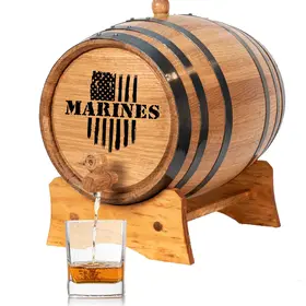 Marines engraved mini oak aging barrel with black steel hoops and wooden stand, dispensing whiskey into glass.