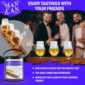 Men enjoying whiskey tasting flight using Man Can barrel stave board and Glencairn glasses in a home bar setting.