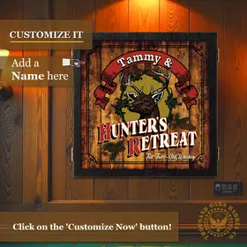 Custom Hunter’s Retreat dartboard cabinet mounted on wood wall with option to add personalized name, rustic hunting lodge decor.
