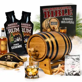 Caribbean rum aging barrel kit with oak barrel, amber rum essence packets, glass of rum, and Bootlegger’s Bible guide.