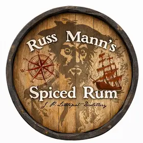 Russ Mann’s Spiced Rum round barrel head wall sign featuring pirate face, compass rose and sailing ship artwork.