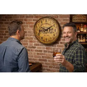 Rustic bourbon barrel clock mounted on brick wall in a bourbon themed game room with two men enjoying whiskey and admiring the personalized barrel clock.
