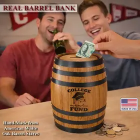 Two college students laughing behind a College Drinking Fund oak barrel piggy bank while one deposits money and the other drinks a beer.