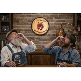 Personalized White Lightning barrel head sign displayed in rustic home distillery bar setting with men enjoying moonshine shots.