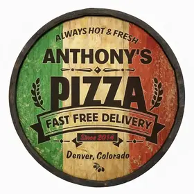 Close up of handmade barrel end pizza sign showing wood texture and bold PIZZA lettering