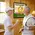 ather and son playing darts in game room with personalized tennis dartboard cabinet on wall