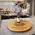 Authentic reclaimed wine barrel lazy susan serving wine glasses and bottle in a kitchen entertaining scene.