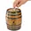 Close up of hand placing a coin into the slot of a mini oak barrel whiskey fund piggy bank