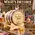 J.D. Pruna & Sons personalized American white oak whiskey aging barrel with charred interior, black steel hoops, wooden stand, bung, spigot, and Bootlegger's Bible aging guide.