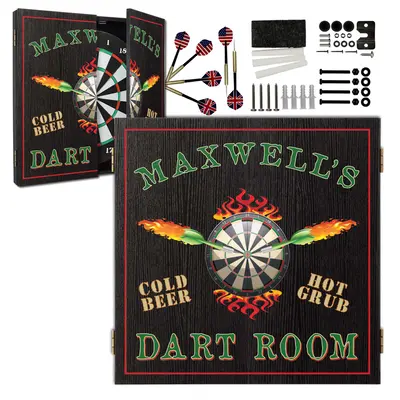 Personalized dartboard cabinet mounted on a wood-paneled wall featuring “Maxwell’s Dart Room” design with flames, dartboard graphic, and bar-style décor accents.