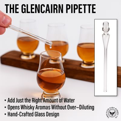 Hand using Glencairn pipette to add water to whisky in a Glencairn glass, with additional glasses on a whisky stave flight board.