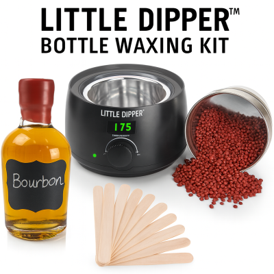 Little Dipper Bottle Waxing Kit with wax warmer, sealing wax pellets, stirring sticks, and a wax-sealed whiskey bottle.