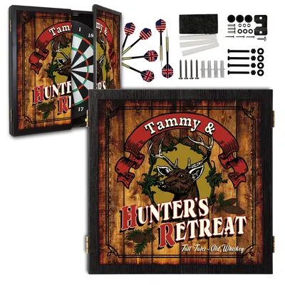 Personalized Hunter’s Retreat dartboard cabinet set with custom name banner, deer head design, rustic wood background, darts and mounting hardware included.