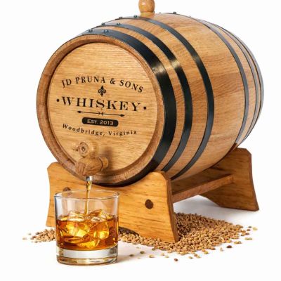 Personalized classic whiskey mini oak aging barrel made from American white oak with custom engraved name and spigot pouring bourbon.
