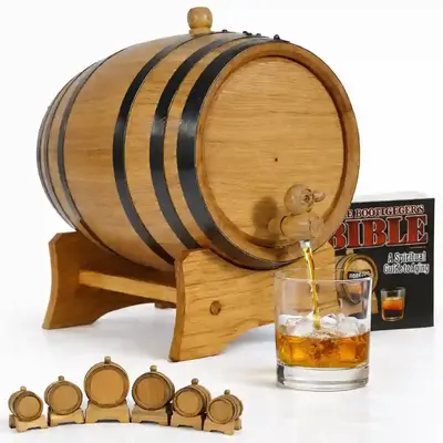 American white oak whiskey aging barrel with spigot pouring bourbon into a clear glass, includes wooden stand and black steel hoops for home bar use.