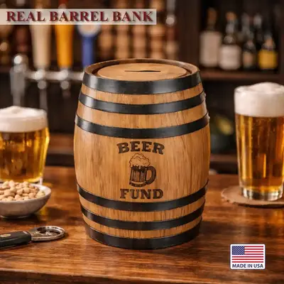 Mini oak barrel beer fund piggy bank sitting on a bar with pints of beer highlighting authentic barrel design