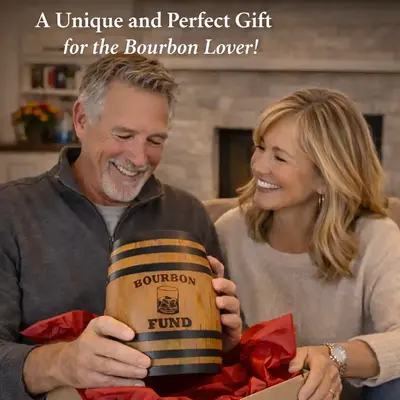 Man receiving bourbon fund oak barrel piggy bank gift with fireplace in background and red gift wrapping