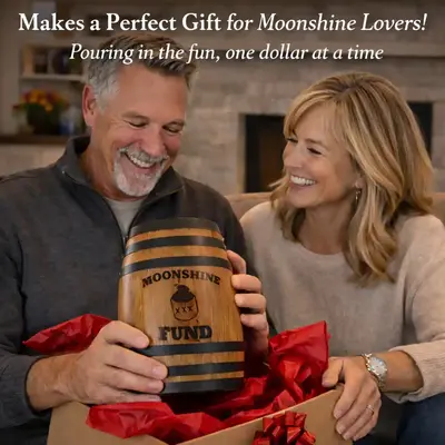 Happy couple opening a Moonshine Fund oak barrel piggy bank gift in a box with red paper making a perfect gift for moonshine lovers.