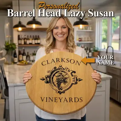 Woman holding personalized barrel head lazy susan with custom engraved vineyard design in bright kitchen wine bar